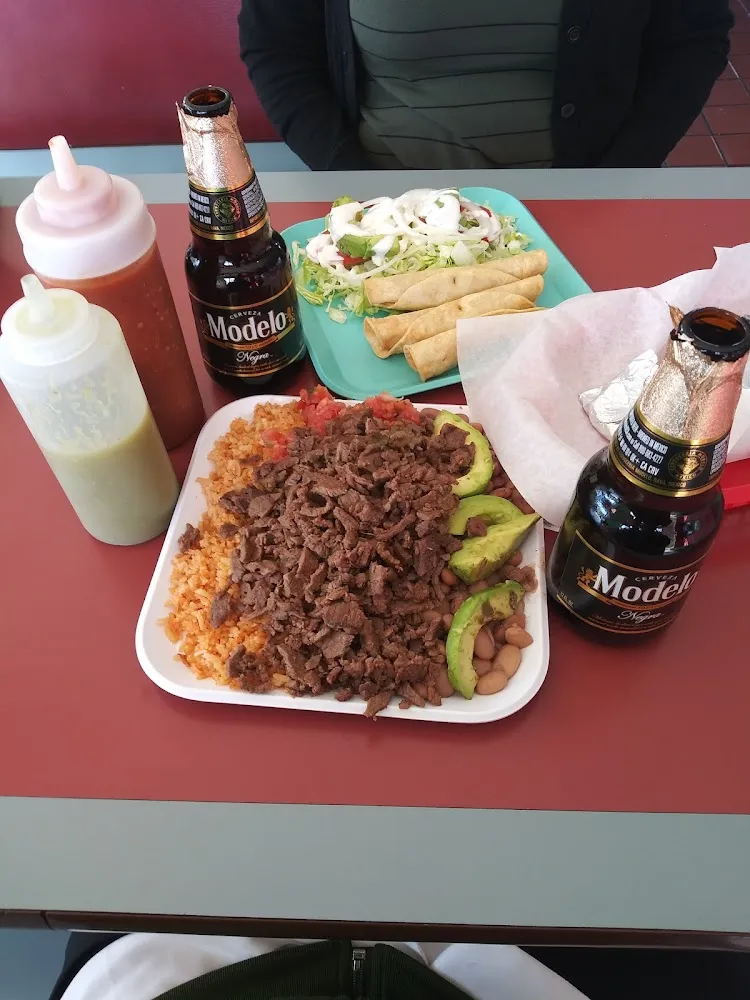Chicken Flautas and Steak Combo Plate with Rice and Beans Salsa and Avocado
